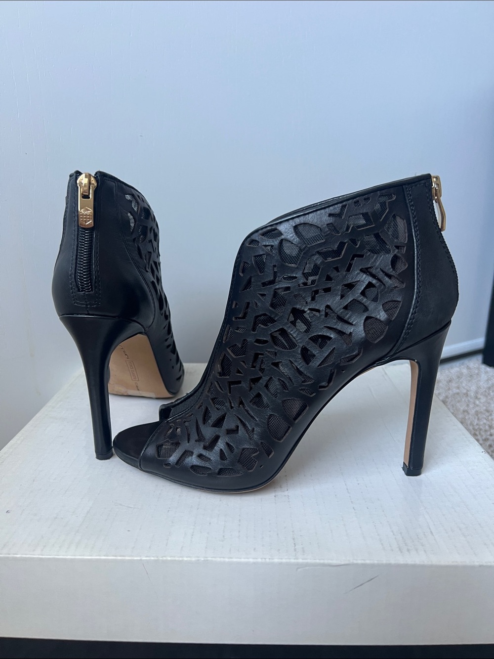 Vince Camuto Black Laser-Cut Peep-Toe Stiletto Booties with Gold Zip